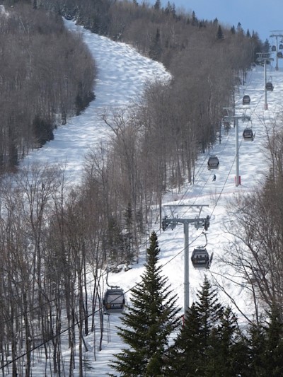 LeMassif Ski Resort Gondola with trails descending to the shoreline of the St Lawrence River.
