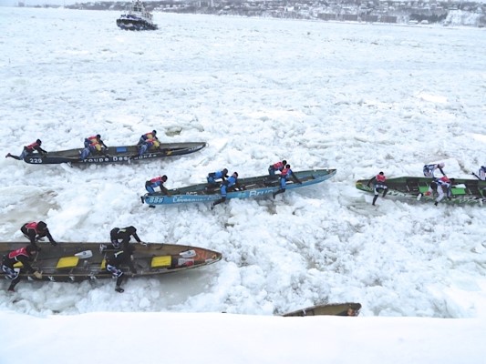 Racers race across the icy St Lawrence River at Quebec City 