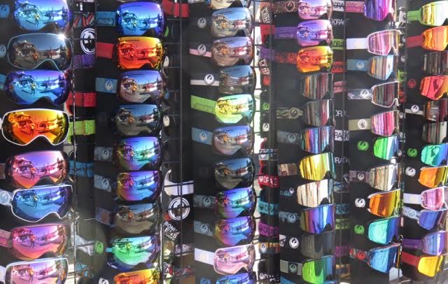 Goggles of all color temperature lenses form a backdrop in a booth