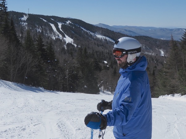 A skier enjoys Bolton Valley at Mid-Mountain enjoying the views