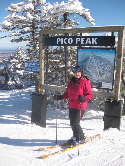 A female skier enjoys the winter wonderland atop Pico Peak Mountain in Vermont