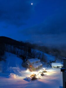 Snow Groomers working under moon