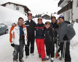 A group of skiers celebrate their run into a rural mountain village deep in the Austrian Arlberg with their Mountain Ski Guide Austria