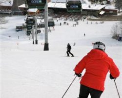 A skier descends under the Gore Mt Gondola headed to the base lodge area A skier descends under the Gore Mt Gondola headed to the base lodge area