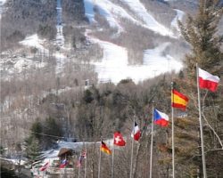 Entrance Road to Whiteface Mt Resort displaying International Flag with Mountain serving as backdrop. Entrance Road to Whiteface Mt Resort displaying International Flag with Mountain serving as backdrop.