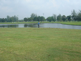 Golfer next to Pond