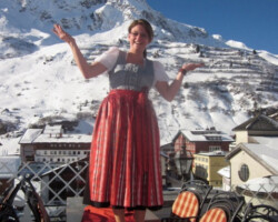 In traditional Austrian dress, a Austrian hotel manager shows off her village of ZÃers, Austria Austria