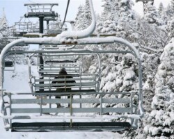 A lone skier is framed on Straight Brook Quad Chairlift enroute to the summit of Gore. A lone skier is framed on Straight Brook Quad Chairlift enroute to the summit of Gore.